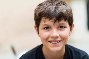 close up and portrait of teenager or boy smiling and looking at the camera