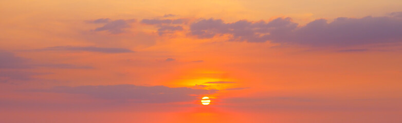 strong sunrise and cloud on the orange sky. Wide photo.