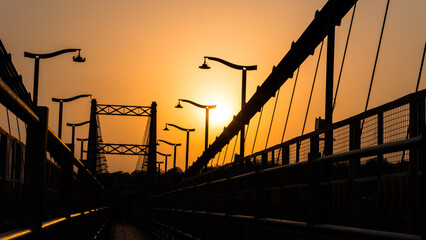 Orange sunset over the Sita Bridge in Rishikesh, Uttarakhand, India