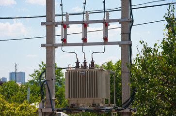 High voltage transformer on poles, fuses and wires.