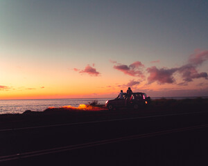 Friends enjoying the sunset after a day of adventures in Hawaii