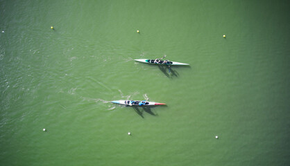 Two boats sculling across rowing canal