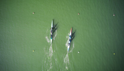 Aerial view of two boats sculling across rowing canal