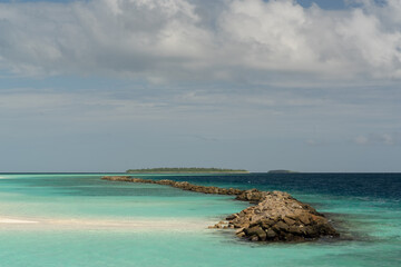 magnificent view of the coral island with a white sandy beach and dense vegetation