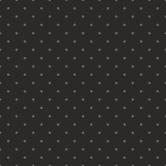 Seamless vector pattern with dark grey polka dots on a black background