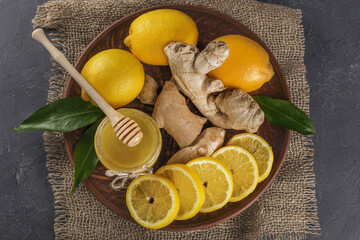 honey, lemon and ginger on wooden background healthy lifestyle