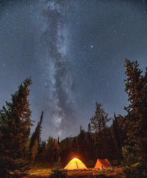 Camping Tents With Milky Way In The Night Sky On Campsite In Autumn Forest At National Park