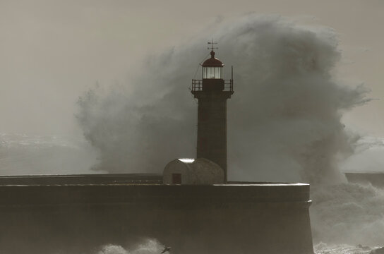ocean waves crashing into the lighthouse