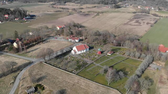 A 4K footage of the Bergum's church near an agricultural field in Sweden