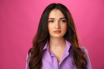 Young beautiful sad woman serious and worried, pink studio background