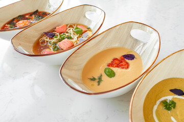 Tom Yam, Miso soup and cream soups on gray table