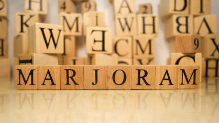 The word Marjoram was created from wooden letter cubes. Gastronomy and spices.