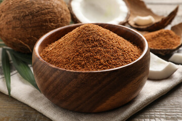 Natural coconut sugar in bowl on wooden table
