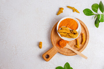 Turmeric powder and fresh roots.