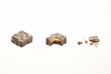 A bitten cookie with crumbs, isolated on white