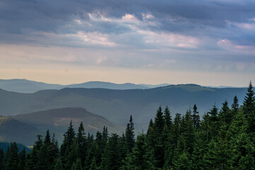 Fototapeta na wymiar sunset in the mountains with distant mountains silhouettes