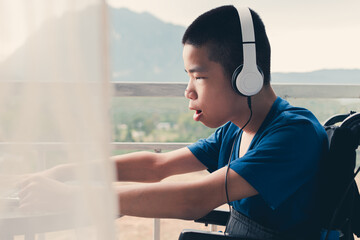 Confident of asian disabled teen boy on wheelchair using computer making video remote learning, Lifestyle in education of disabled kid, Homeschooling concept.