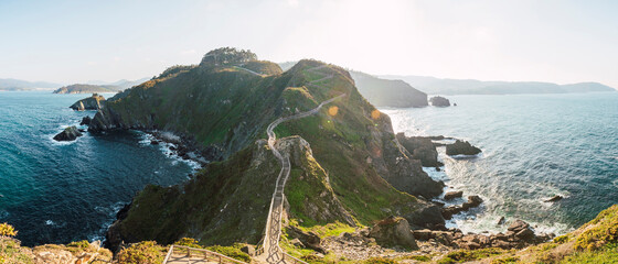 Panorama of elevated walkway stretching along coastal cliffs at sunset