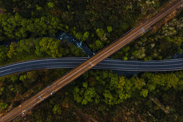 Aerial view of highway stretching under old viaduct