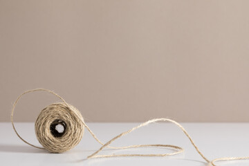 Skein of jute twine on beige table. Front view. mockup