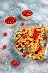Homemade waffles with raspberries and red currants.