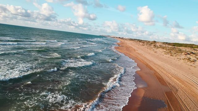Aerial panoramic view of empty sandy beach of La Mata in the early morning. First person view motion. Costa Blanca. Province of Alicante. Torrevieja. Spain. Travel concept