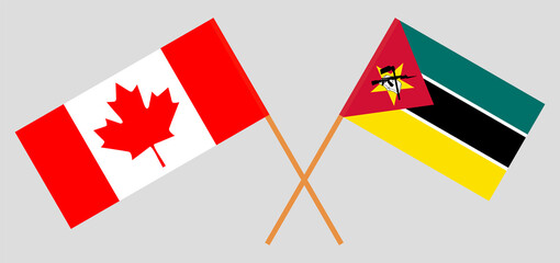 Crossed flags of Canada and Mozambique. Official colors. Correct proportion