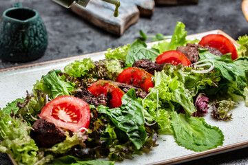 Warm salad from chicken liver grilled, salad leaves, parmesan cheese and cherry tomatoes. Healthy food. Dietary menu. Top view. Flat lay