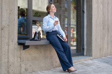 happy confident business woman with books drinking coffee stand in city 