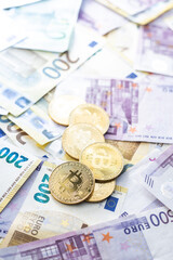 Euro banknotes and bitcoins. Golden cryptocurrency.