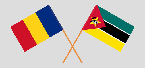 Crossed flags of Romania and Mozambique. Official colors. Correct proportion