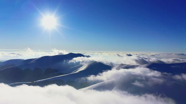 Wonderful view of extraordinary cloudy valley and bright orange sunset