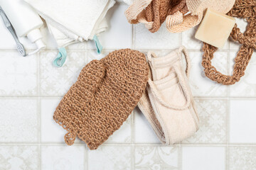 natural bathroom accessories, bath sponges for the body, soap and towels on a light background. environmentally friendly house