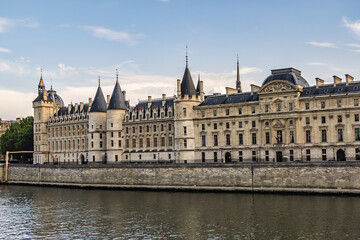 Fototapeta na wymiar Castle Conciergerie - former royal palace and prison. Conciergerie located on the west of the Cite Island and today it is part of larger complex known as Palais de Justice. Paris, France. Sunset.