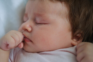 cute little baby girl lying sleep on white plaid. Happy family