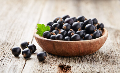 Black currants leaves on old wooden background