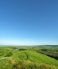 Naklejka premium Panorama of meadows, fields and the small town of Rohatyn on a sunny day in summer in Ukraine