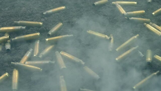 Smoke Rushes Over Bullet Shells On The Ground