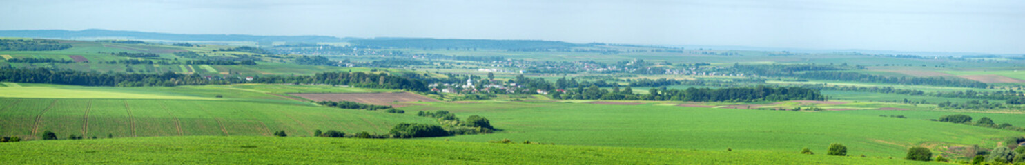 Panorama of meadows, fields and the small town of Rohatyn on a sunny day in summer in Ukraine