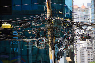 poles full of telecommunication cables in the city