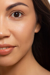 Fototapeta premium Close-up portrait of a beauty woman with full lips, straight hair and perfectly clean skin. Daytime makeup, styling and soft care. Skin care in the spa salon or cosmetology, smooth eyebrows