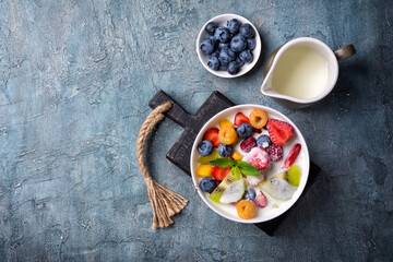 Bowl of healthy salad with fresh fruits, berries and yogurt