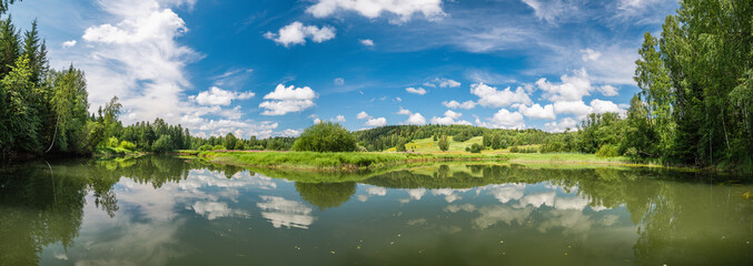Panoramic landscape of a calm River. Reflection Of Clouds On The Lake.
