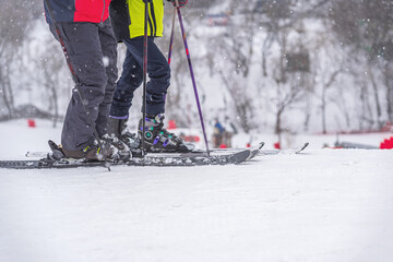 Two abstract skiers on ski slope, snow day, selective focus. Winter sport and recreation concept