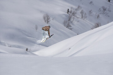 Naklejka na ściany i meble Skier jumps in the mountains. Mountain ski, winter extreme sport.