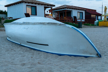 A rescue boat on a sandy beach near some houses