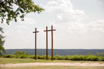 Trzy drewniane krzyże na wzgórzu