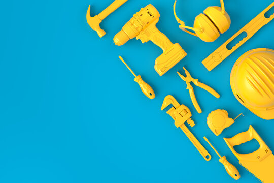 Top view of monochrome construction tools for repair on blue and yellow