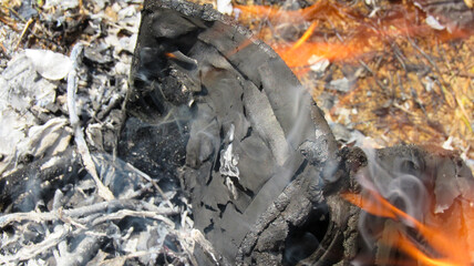 A smoldering document in the flames of fire