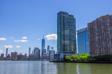 Lower Manhattan skyscraper stands in Manhattan Ward beyond the Hudson River behind the Luxury high-rise apartments at New Jersey Ward in Jersey City USA on May 14 2021.